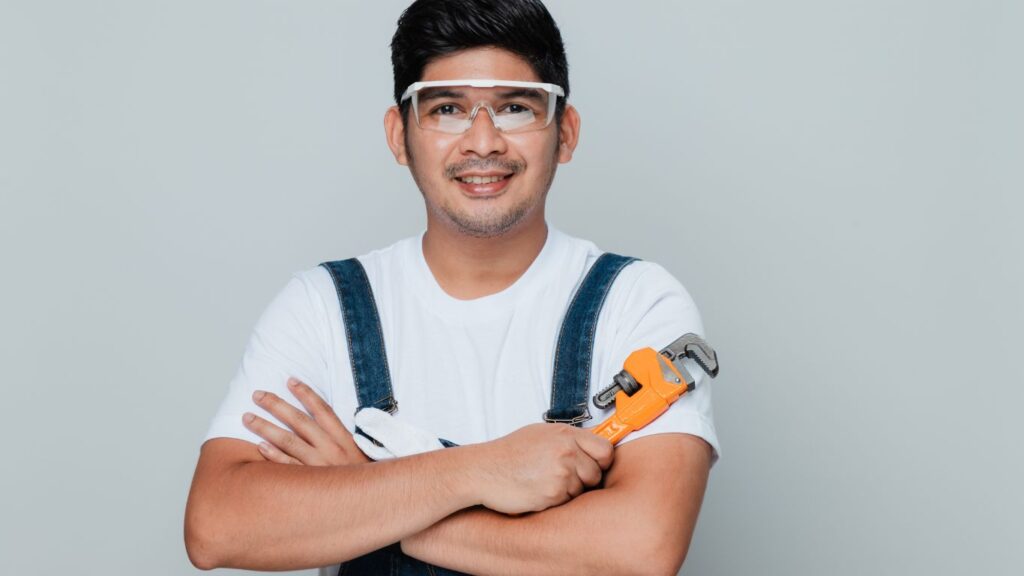 A plumber holding a wrench.