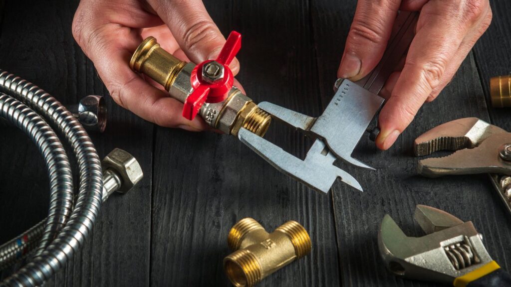 Plumber measuring the pipes.